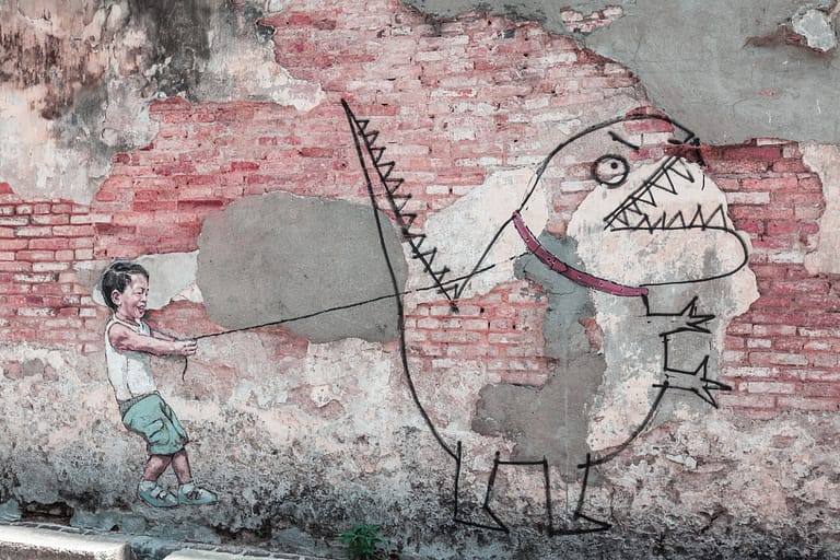 Explore the Iconic Street Art of Penang: Little boy with pet dinosaur